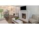 Cozy living room with a fireplace, television, and a view of the dining area and kitchen at 125 Warren Ne St, Atlanta, GA 30317