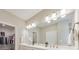 Modern bathroom features double vanity sinks with a large mirror and decorative lighting at 124 Redford Ln, Canton, GA 30115