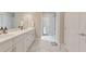Bright bathroom featuring dual sinks, marble floors, and natural light at 124 Redford Ln, Canton, GA 30115