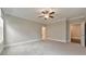 Spacious bedroom with plush carpet, ceiling fan, and ensuite bath at 124 Redford Ln, Canton, GA 30115