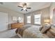 Well-lit bedroom with a ceiling fan, carpet, and windows overlooking the neighborhood at 124 Redford Ln, Canton, GA 30115