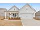 Charming one-story home with a well-manicured lawn and covered porch with rocking chairs at 124 Redford Ln, Canton, GA 30115