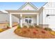 Inviting front porch with rocking chairs and beautiful landscaping enhances the curb appeal at 124 Redford Ln, Canton, GA 30115