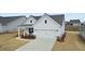 Exterior view showcasing a home's attached garage and inviting covered front porch with seating at 124 Redford Ln, Canton, GA 30115