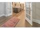 View of kitchen from office features a large island with stainless steel appliances at 124 Redford Ln, Canton, GA 30115