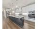 Bright, modern kitchen features a large island, stainless steel appliances and hardwood floors at 124 Redford Ln, Canton, GA 30115