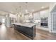 Gourmet kitchen featuring a large island, stainless steel appliances, and custom cabinetry at 124 Redford Ln, Canton, GA 30115