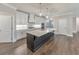 Bright modern kitchen features large island, stainless steel appliances, and open concept design at 124 Redford Ln, Canton, GA 30115