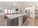 Open concept kitchen boasts an oversized island, stainless steel appliances, and seamless transition to the living area at 124 Redford Ln, Canton, GA 30115