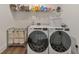 Functional laundry room with washer, dryer, shelving, and ample storage space at 124 Redford Ln, Canton, GA 30115