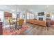 Open-concept living room with hardwood floors, large windows, fireplace, and comfortable seating at 124 Redford Ln, Canton, GA 30115