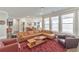 Inviting living room featuring a large sectional couch, modern decor, and abundant natural light at 124 Redford Ln, Canton, GA 30115