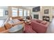 Cozy living room boasts fireplace, leather sectional, and large windows for natural light at 124 Redford Ln, Canton, GA 30115