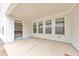 Covered patio featuring concrete flooring and white siding with a view to the interior at 124 Redford Ln, Canton, GA 30115