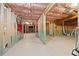 Large unfinished basement framed with exposed pink insulation and ceiling beams at 1656 Maes Overlook, Loganville, GA 30052