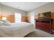 Cozy bedroom with large dresser and TV, plus neutral decor at 1656 Maes Overlook, Loganville, GA 30052