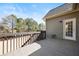 Spacious wooden deck overlooking serene wooded area, accessible via back door at 1656 Maes Overlook, Loganville, GA 30052