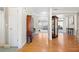 Elegant hallway featuring hardwood floors, white trim, and views into the living spaces at 1656 Maes Overlook, Loganville, GA 30052
