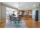 Bright kitchen with wooden cabinets, stainless steel appliances, and an eat-in dining area at 1656 Maes Overlook, Loganville, GA 30052