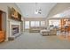 Open-concept living area with fireplace, large windows, and seamless transition to the kitchen at 1656 Maes Overlook, Loganville, GA 30052