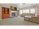 Inviting living room with a stone fireplace, built-in shelves, and a comfortable sectional sofa at 1656 Maes Overlook, Loganville, GA 30052