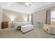 The main bedroom with neutral walls, plush carpet, and a ceiling fan at 1656 Maes Overlook, Loganville, GA 30052