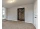 Spacious carpeted basement featuring a doorway to unfinished storage space with a stone foundation at 3783 Brookcrest Cir, Decatur, GA 30032