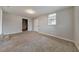 Spacious carpeted basement featuring a doorway to unfinished storage space and window for light at 3783 Brookcrest Cir, Decatur, GA 30032
