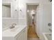 Bathroom featuring a vanity and mirror with a view into the hallway with hardwood floors at 3783 Brookcrest Cir, Decatur, GA 30032