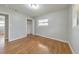 Sunlit bedroom with gleaming hardwood floors, featuring a closet and a bright window at 3783 Brookcrest Cir, Decatur, GA 30032