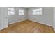 A bright bedroom features hardwood floors and two windows bringing in plenty of natural light at 3783 Brookcrest Cir, Decatur, GA 30032