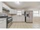 Bright kitchen with stainless steel appliances, and tile floor at 3783 Brookcrest Cir, Decatur, GA 30032