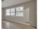 Open living room with new floors and natural light from a large window at 3783 Brookcrest Cir, Decatur, GA 30032