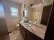 Bathroom featuring single vanity, decorative mirror and shower-tub combo at 403 Pine Ridge Ct, Woodstock, GA 30188