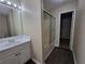 Cozy bathroom with a single sink vanity and shower with a glass door at 916 Hunt Rd, Jonesboro, GA 30236