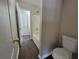 View of the tub and toilet in a bathroom with neutral paint and vinyl plank flooring at 916 Hunt Rd, Jonesboro, GA 30236