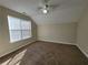 Spacious bedroom features neutral walls, carpet, and a ceiling fan, illuminated by natural light from a window at 916 Hunt Rd, Jonesboro, GA 30236