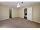 Bright bedroom with neutral walls, plush carpet, and a ceiling fan at 916 Hunt Rd, Jonesboro, GA 30236