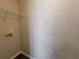 Small closet with wire shelving and utility hookup at 916 Hunt Rd, Jonesboro, GA 30236