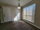 Cozy dining area featuring wood floors, a chandelier, and a sunlit window at 916 Hunt Rd, Jonesboro, GA 30236