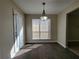 Cozy dining area with a modern chandelier and lots of natural light at 916 Hunt Rd, Jonesboro, GA 30236