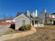 Charming front exterior with stone facade, dormer windows, and cozy front porch at 916 Hunt Rd, Jonesboro, GA 30236