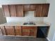 Functional kitchen featuring wood cabinets, laminate countertops and black appliances at 916 Hunt Rd, Jonesboro, GA 30236