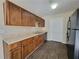 Functional kitchen with wood cabinets, laminate countertops, and vinyl flooring at 916 Hunt Rd, Jonesboro, GA 30236