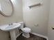 Half bathroom featuring a pedestal sink and a decorative oval mirror at 916 Hunt Rd, Jonesboro, GA 30236