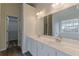 Bathroom with double sinks, large mirror, tile backsplash and separate toilet area at 239 Gilliam Ct, Locust Grove, GA 30248