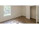 Sunlit bedroom has a closet and a view to the trees outside the large window at 239 Gilliam Ct, Locust Grove, GA 30248