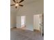 Bright bedroom with ensuite bathroom and entrance featuring carpeted floors and vaulted ceiling at 239 Gilliam Ct, Locust Grove, GA 30248