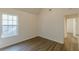 Bright bedroom with wood floors and a view to a hallway at 239 Gilliam Ct, Locust Grove, GA 30248