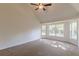 Bright bedroom features carpeted floor, a ceiling fan and an array of windows at 239 Gilliam Ct, Locust Grove, GA 30248